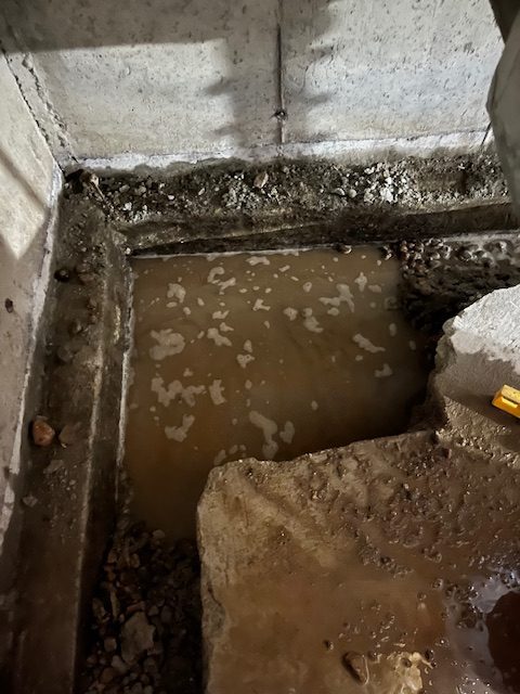 basement with foundation leak before basement waterproof interior project