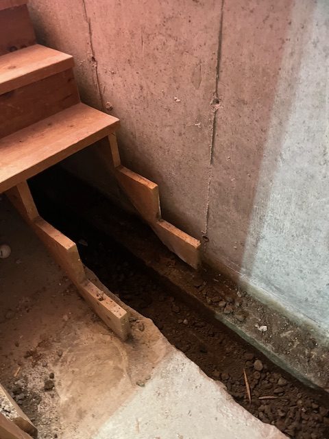 basement excavation during work on interior basement waterproofing service