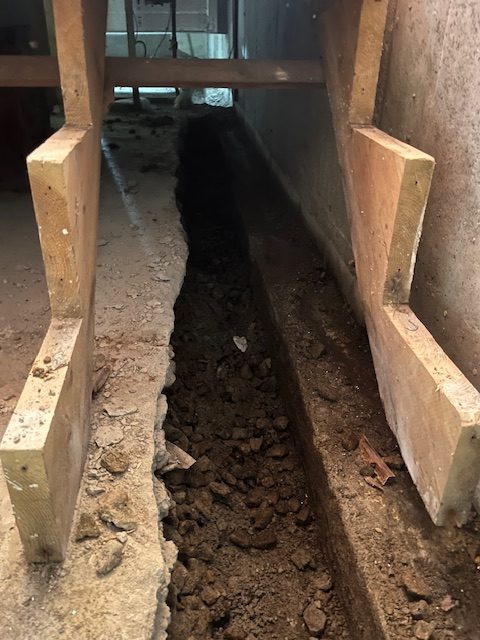 basement excavation during work on interior basement waterproofing service