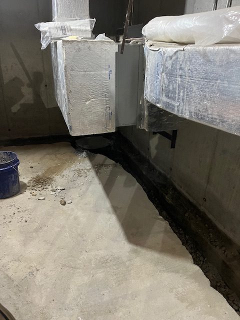 basement detail while team is working on interior basement waterproofing service